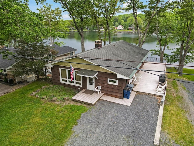 300 Indian Lake Trl, White Haven, PA 18661 - view of front of house featuring roof with shingles, a deck with water view, and a front lawn