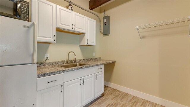 300 Indian Lake Trl, White Haven, PA 18661 - kitchen featuring freestanding refrigerator, a sink, black microwave, light wood finished floors, and baseboards