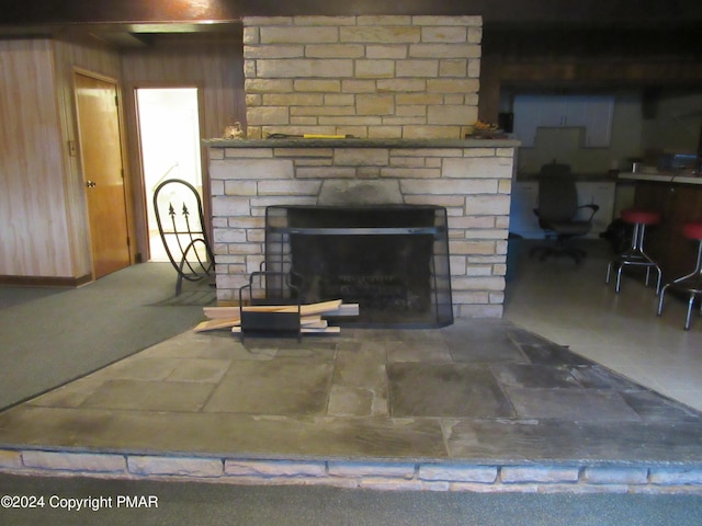 interior details featuring a stone fireplace