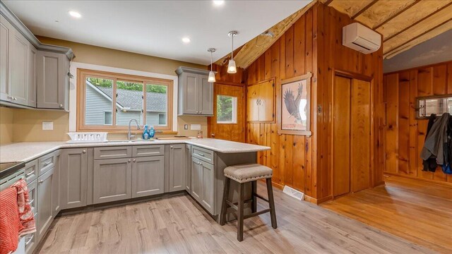 300 Indian Lake Trl, White Haven, PA 18661 - kitchen with gray cabinets, a sink, a wall mounted air conditioner, light countertops, and vaulted ceiling