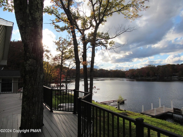 wooden deck featuring a dock and a water view