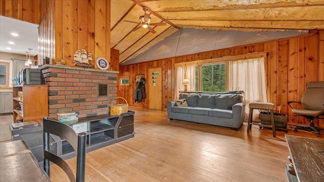 300 Indian Lake Trl, White Haven, PA 18661 - living room featuring wood walls, light wood finished floors, vaulted ceiling, and a ceiling fan