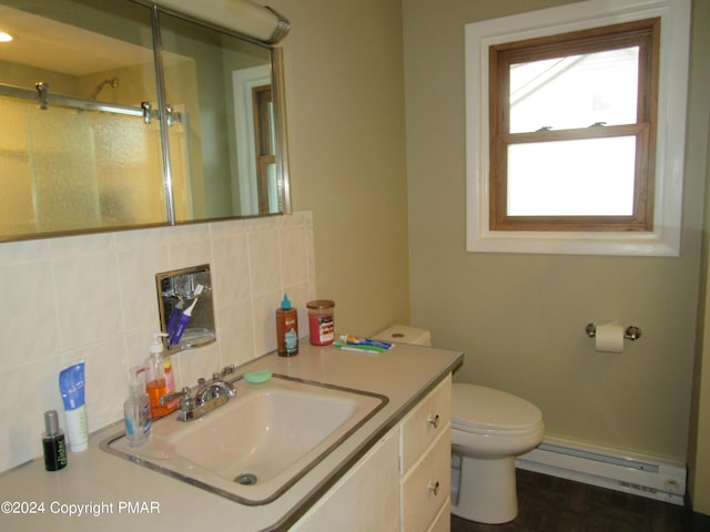 full bath featuring tasteful backsplash, toilet, a baseboard radiator, vanity, and a shower stall