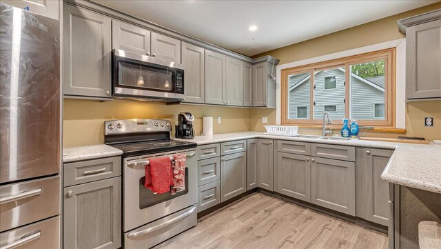 300 Indian Lake Trl, White Haven, PA 18661 - kitchen with stainless steel appliances, a sink, gray cabinetry, light wood-type flooring, and recessed lighting