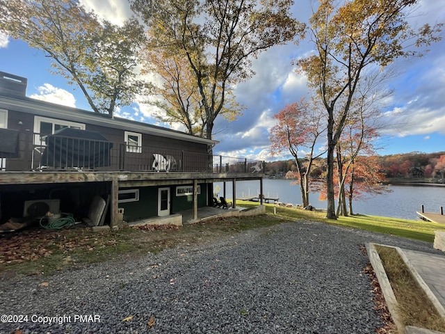 exterior space featuring a deck with water view