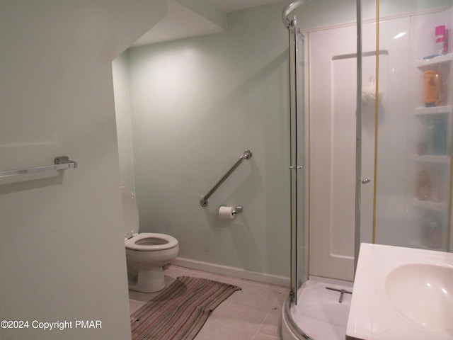 bathroom featuring a stall shower, baseboards, toilet, tile patterned floors, and vanity