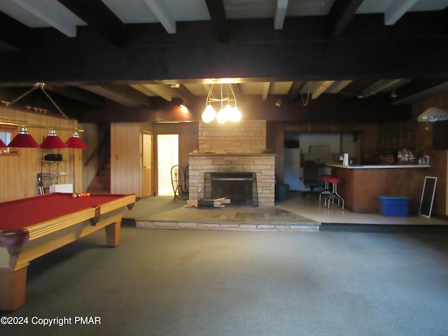 rec room with a large fireplace, billiards, wooden walls, and beam ceiling