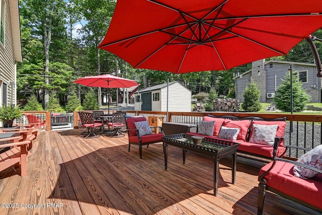 wooden terrace with outdoor dining area and an outdoor living space