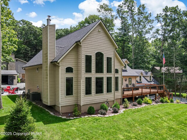 back of property with a yard and a deck