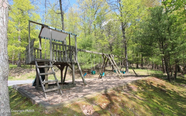 communal playground featuring a forest view