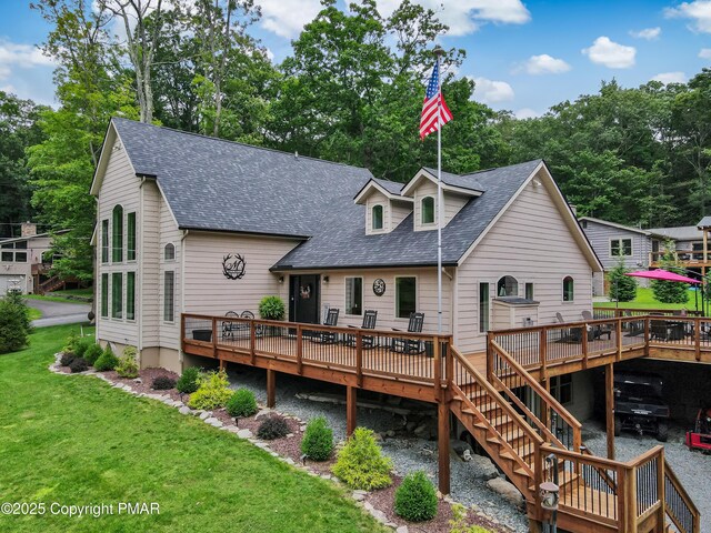 back of house featuring a wooden deck and a lawn