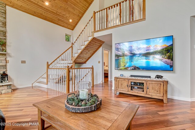 living room with wood-type flooring, wood ceiling, and high vaulted ceiling