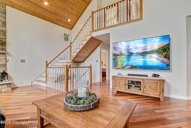 living area featuring high vaulted ceiling, wood finished floors, wood ceiling, and baseboards