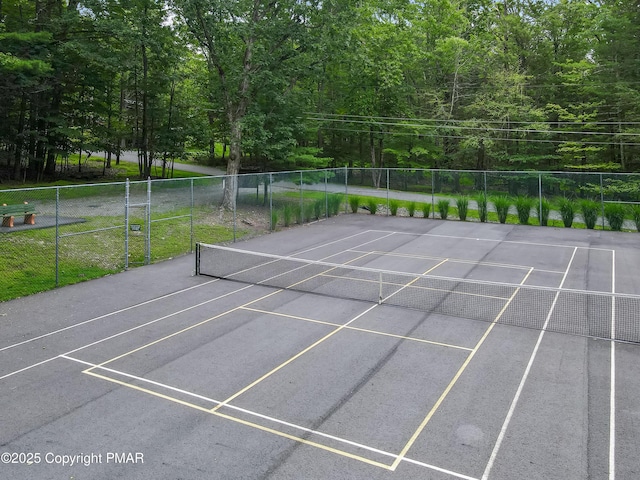 view of sport court featuring fence