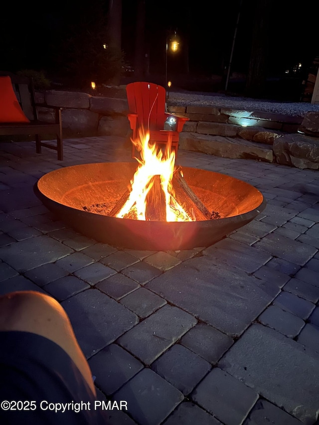 view of swimming pool featuring an outdoor fire pit and a patio