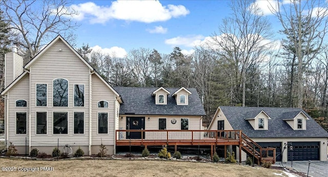 view of front of property with a garage, stairway, and a wooden deck