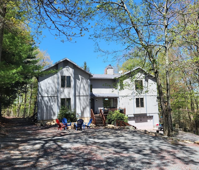 74 Split Rock Rd, Lake Harmony, PA 18624 - view of front of property featuring a chimney, stairway, and an outdoor fire pit