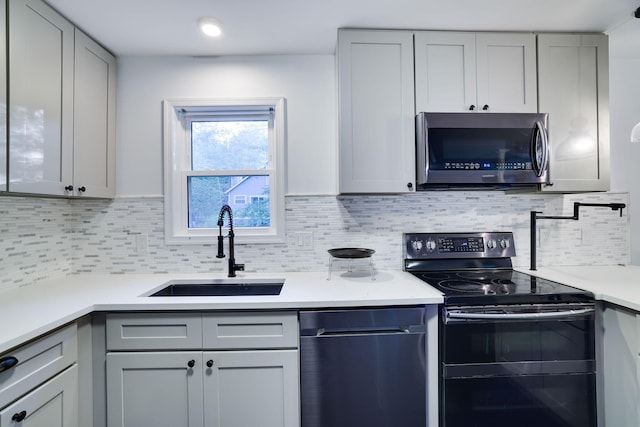 9436 Juniper Dr, Tobyhanna, PA 18466 - kitchen featuring stainless steel appliances, gray cabinets, light countertops, and tasteful backsplash