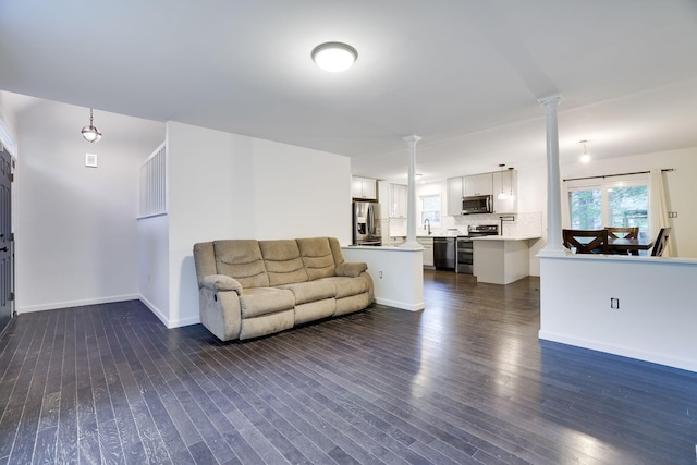 9436 Juniper Dr, Tobyhanna, PA 18466 - living room featuring dark wood finished floors and decorative columns