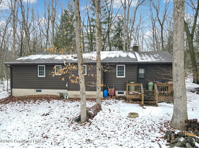 view of snow covered back of property