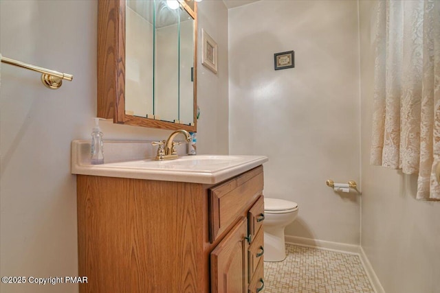 bathroom featuring vanity, toilet, and tile patterned flooring