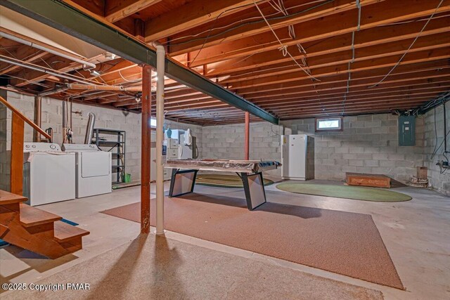 basement featuring electric panel and independent washer and dryer