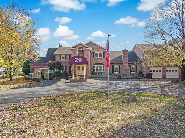 view of front facade featuring driveway and brick siding