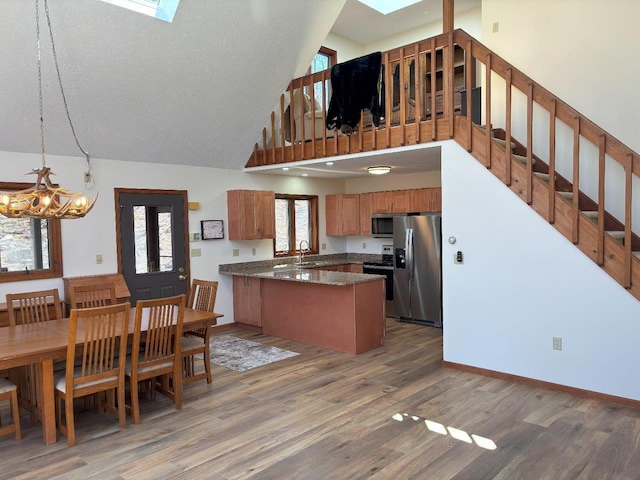 113 Mountainside Dr, Gouldsboro, PA 18424 - kitchen with a skylight, stainless steel appliances, a peninsula, and light wood finished floors