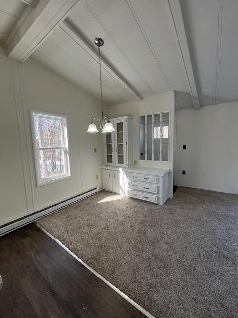 unfurnished dining area featuring lofted ceiling with beams, a notable chandelier, and a baseboard radiator