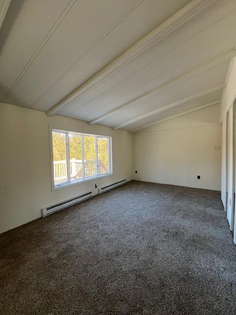 spare room with lofted ceiling with beams, carpet, and baseboard heating