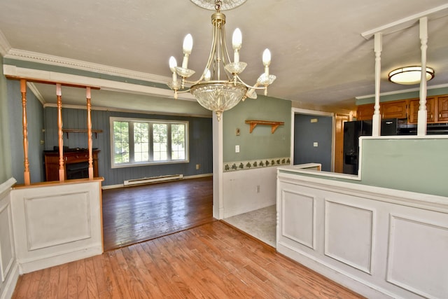 kitchen featuring a chandelier, light wood finished floors, a baseboard radiator, black refrigerator with ice dispenser, and baseboards
