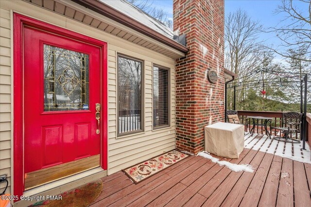 view of exterior entry featuring a deck