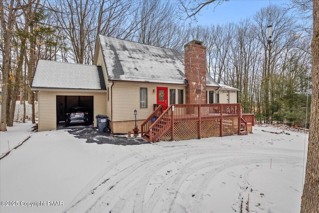 view of front of home featuring a wooden deck and a garage