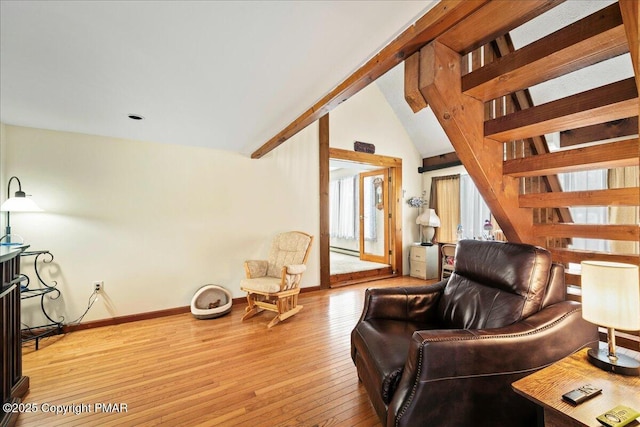 living area featuring vaulted ceiling with beams, baseboards, and hardwood / wood-style flooring