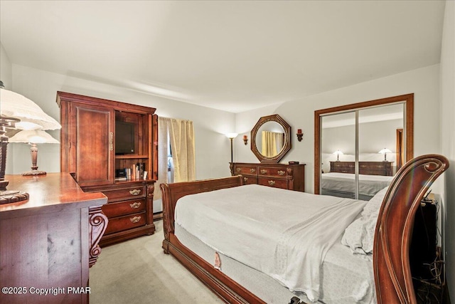 bedroom featuring a closet and light colored carpet