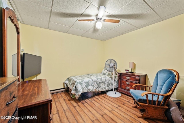 6 Cobblewood Dr, Mount Pocono, PA 18344 - bedroom featuring a paneled ceiling, wood finished floors, a ceiling fan, and baseboard heating
