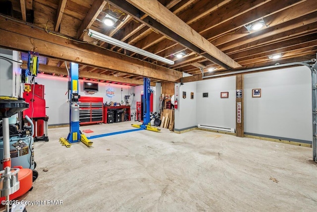 basement with a garage, a baseboard radiator, and a workshop area