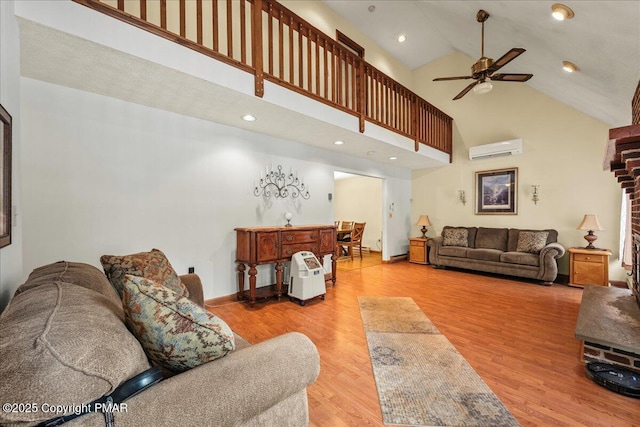 living room with high vaulted ceiling, recessed lighting, wood finished floors, a ceiling fan, and a wall mounted AC