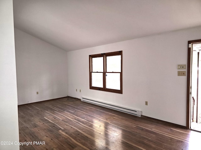 unfurnished room with a baseboard heating unit, vaulted ceiling, and dark wood-style flooring