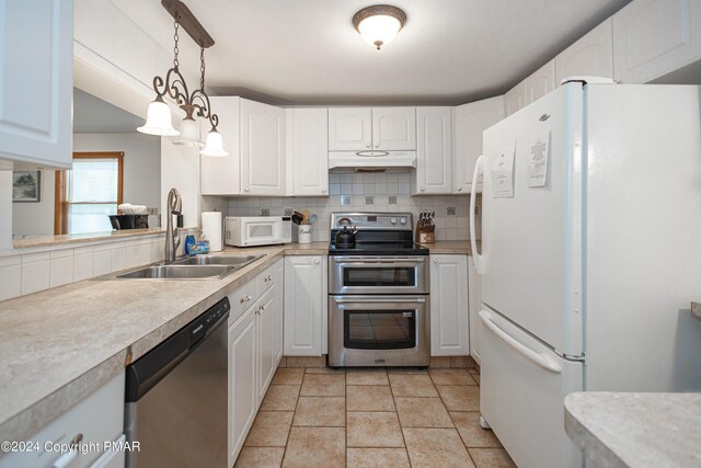 151 S Lake Dr, Lake Harmony, PA 18624 - kitchen with tasteful backsplash, stainless steel appliances, under cabinet range hood, white cabinetry, and a sink