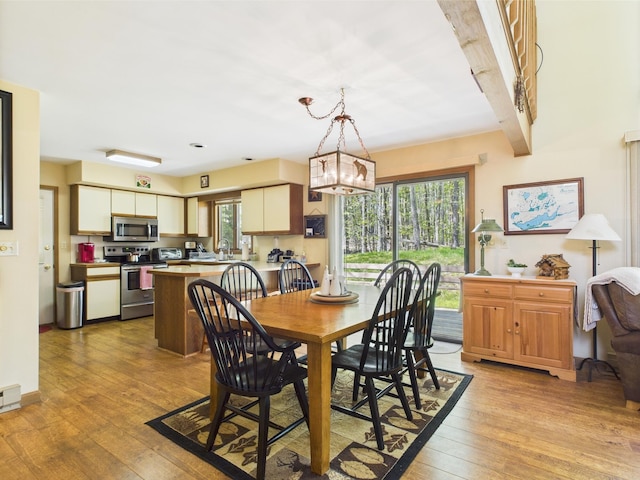 5541 Fox Rd, Pocono Pines, PA 18350 - dining area featuring plenty of natural light, light wood-style floors, beam ceiling, and a chandelier