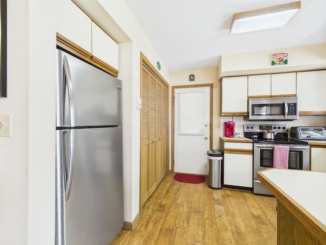 5541 Fox Rd, Pocono Pines, PA 18350 - kitchen featuring appliances with stainless steel finishes, white cabinetry, light wood-style floors, and light countertops