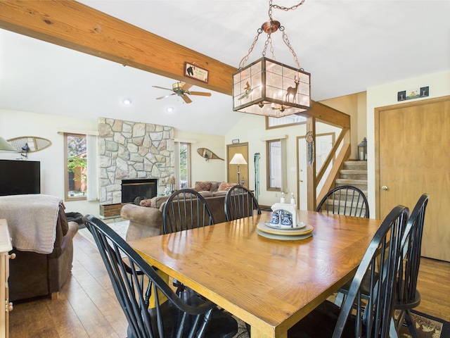 5541 Fox Rd, Pocono Pines, PA 18350 - dining room with a stone fireplace, wood finished floors, stairway, and ceiling fan
