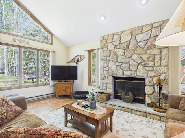 5541 Fox Rd, Pocono Pines, PA 18350 - living area featuring a baseboard radiator, high vaulted ceiling, wood finished floors, and a stone fireplace