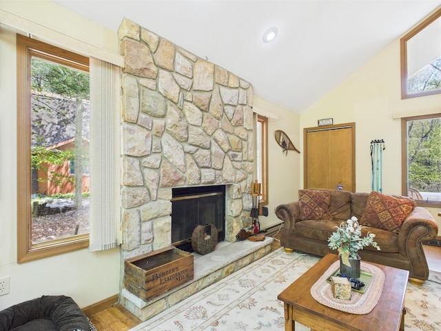 5541 Fox Rd, Pocono Pines, PA 18350 - living area with wood finished floors, baseboard heating, a fireplace, baseboards, and high vaulted ceiling