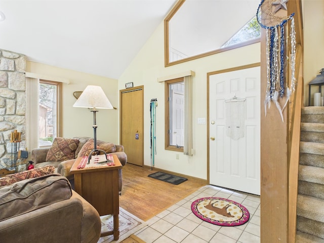 5541 Fox Rd, Pocono Pines, PA 18350 - entrance foyer with stairs, healthy amount of natural light, light tile patterned flooring, and high vaulted ceiling