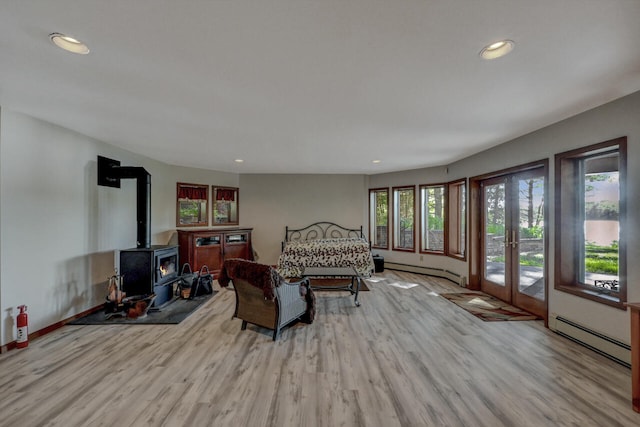 210 Egret Way E, Stroudsburg, PA 18302 - living room featuring a baseboard heating unit, wood finished floors, a wood stove, and recessed lighting