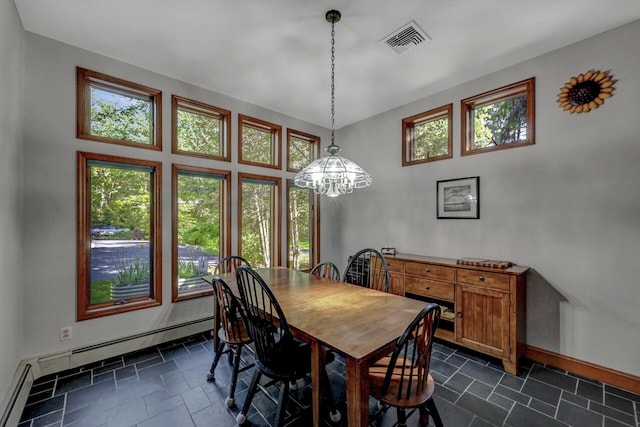 210 Egret Way E, Stroudsburg, PA 18302 - dining room with baseboards, a baseboard radiator, stone tile floors, and a chandelier
