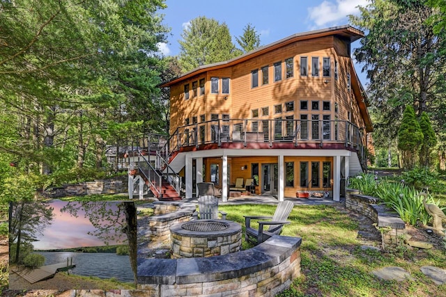 210 Egret Way E, Stroudsburg, PA 18302 - back of property with a fire pit, a deck with water view, stairs, and a patio area