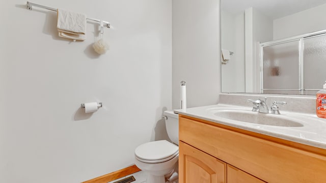 full bath with a shower stall, toilet, and vanity